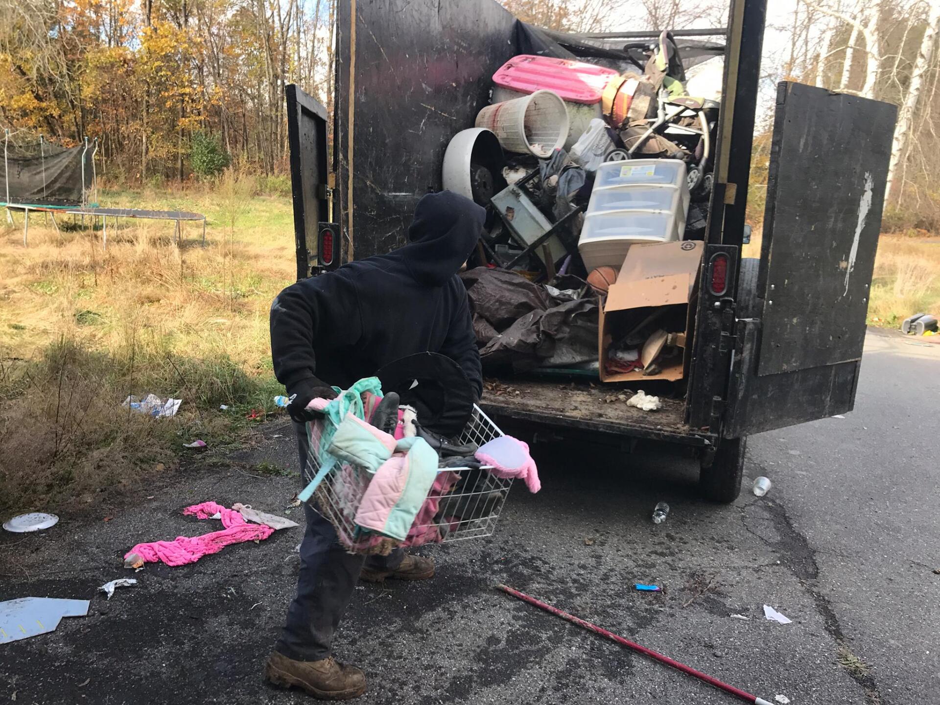 Man Moving Junk To Truck | Rock Hill, NY | Garcia’s Property Preservation