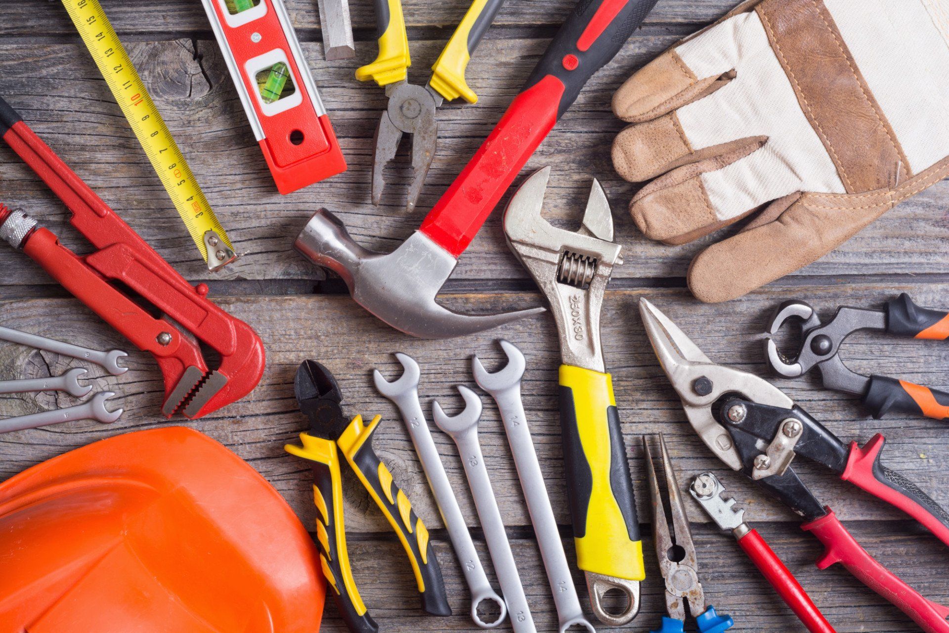 a bunch of tools are sitting on a wooden table .