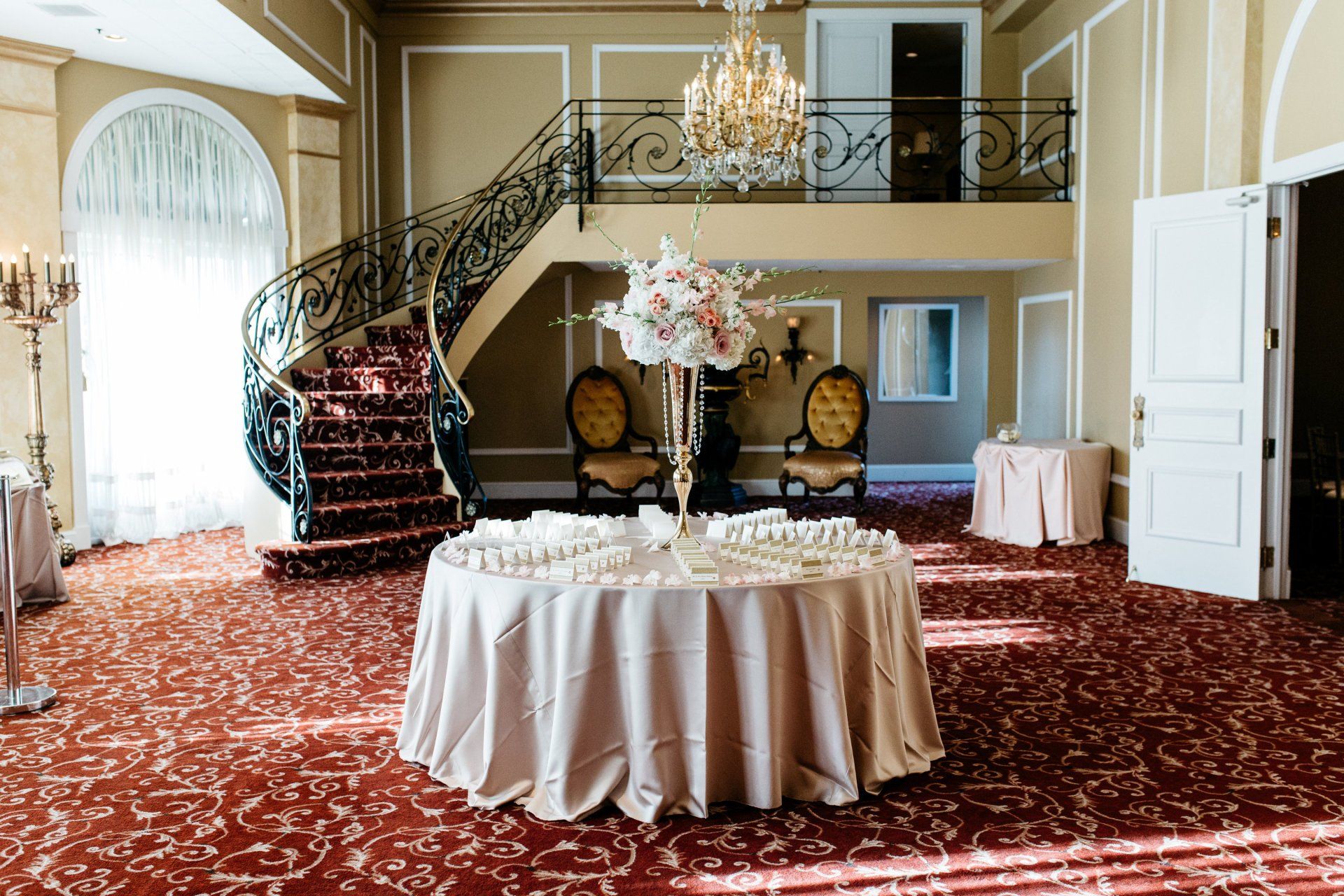 There is a table with flowers on it in the middle of the room.