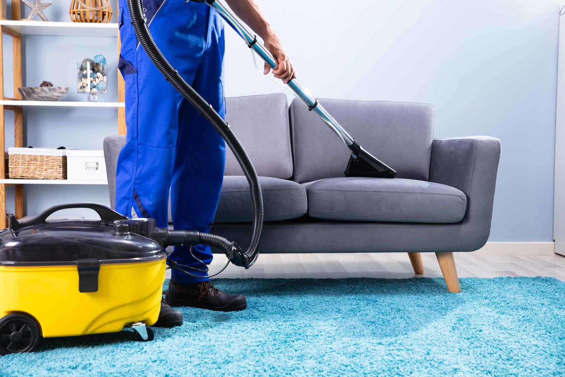 Man Cleaning Sofa With Vacuum Cleaner — Middletown, NY — Right Source Cleaning Service LLC Man Cleaning Sofa With Vacuum Cleaner — Middletown, NY — Right Source Cleaning Service LLC