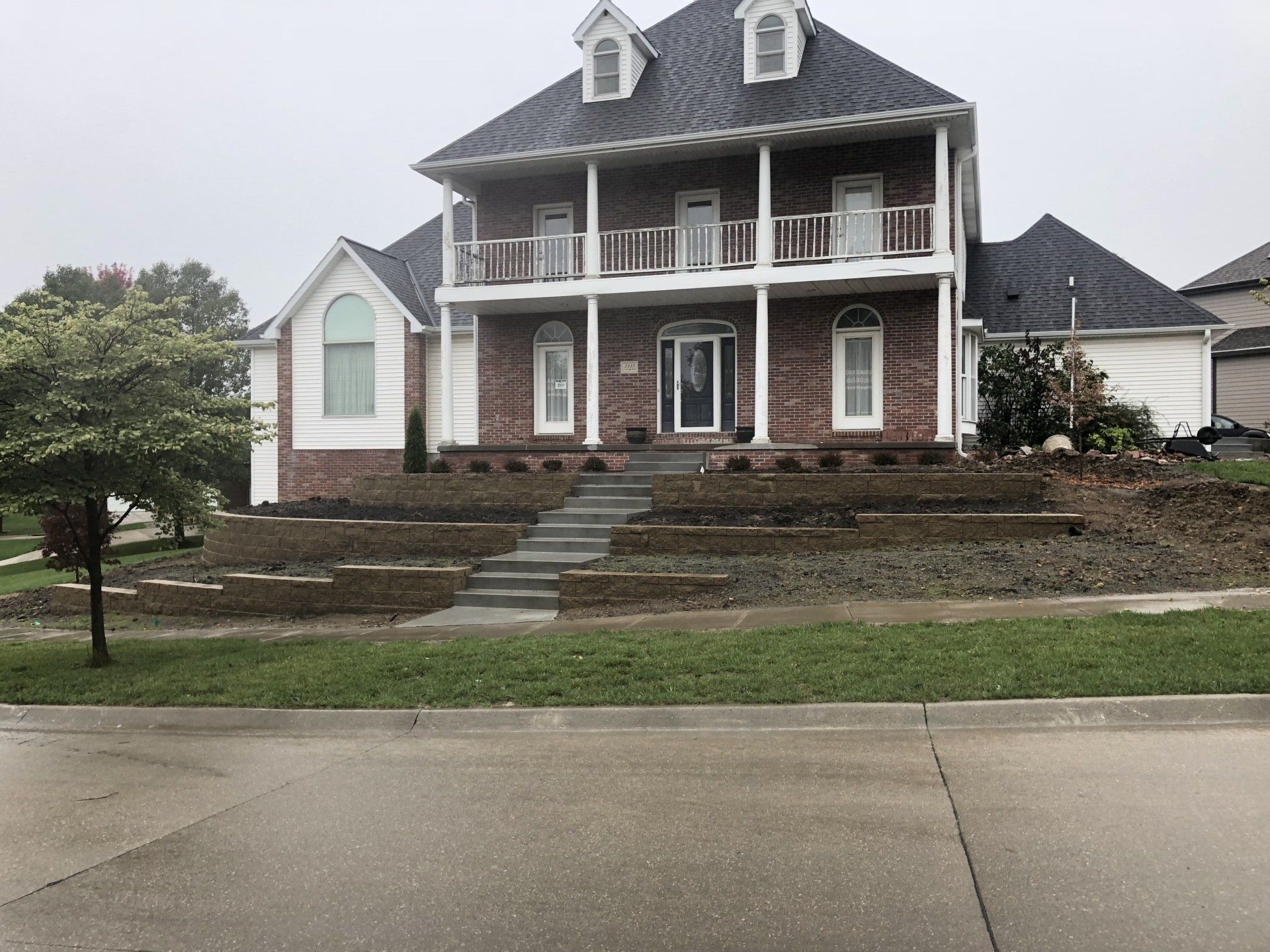 A large brick house with stairs leading up to it