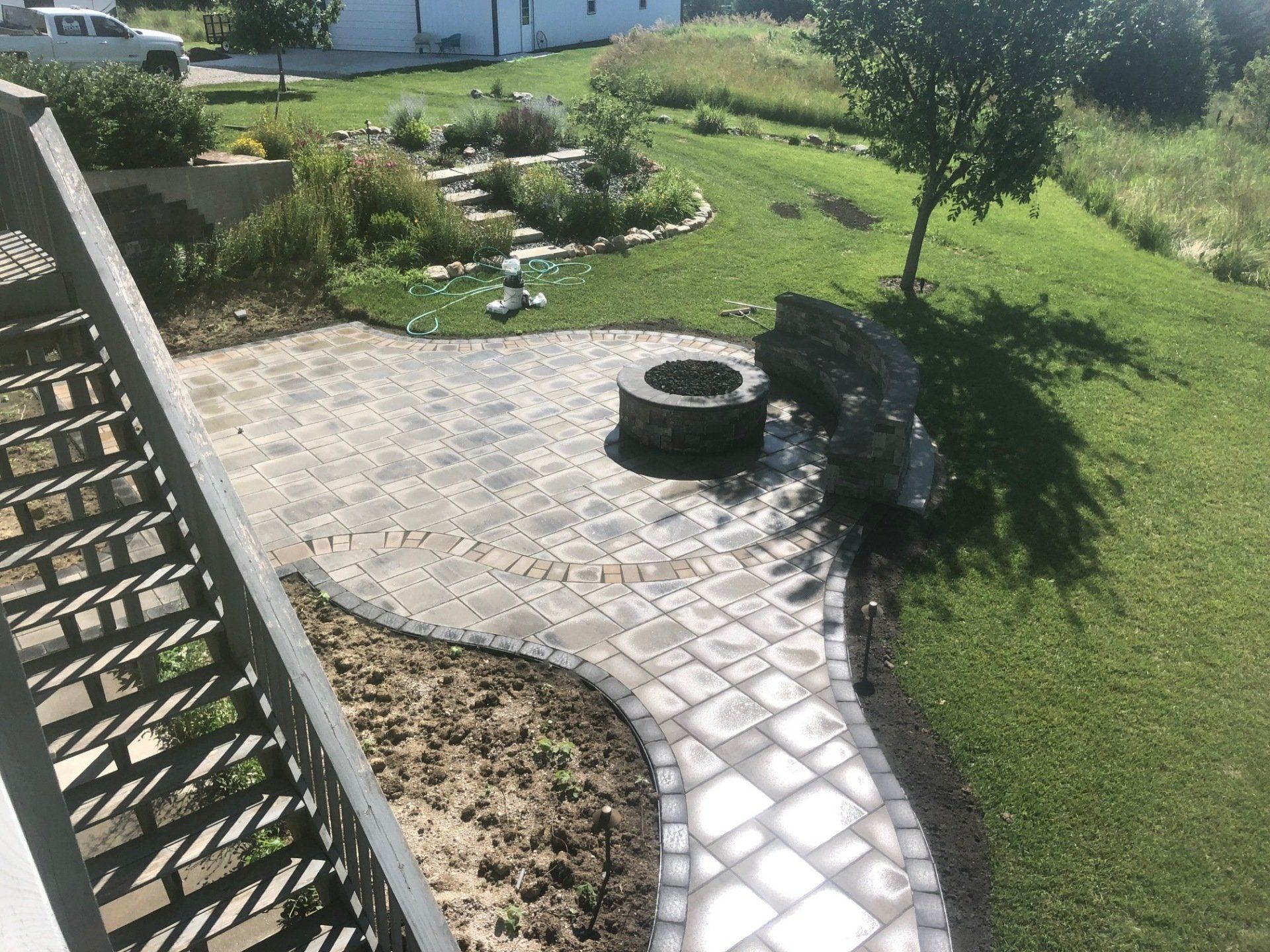 A patio with a fire pit in the middle of it