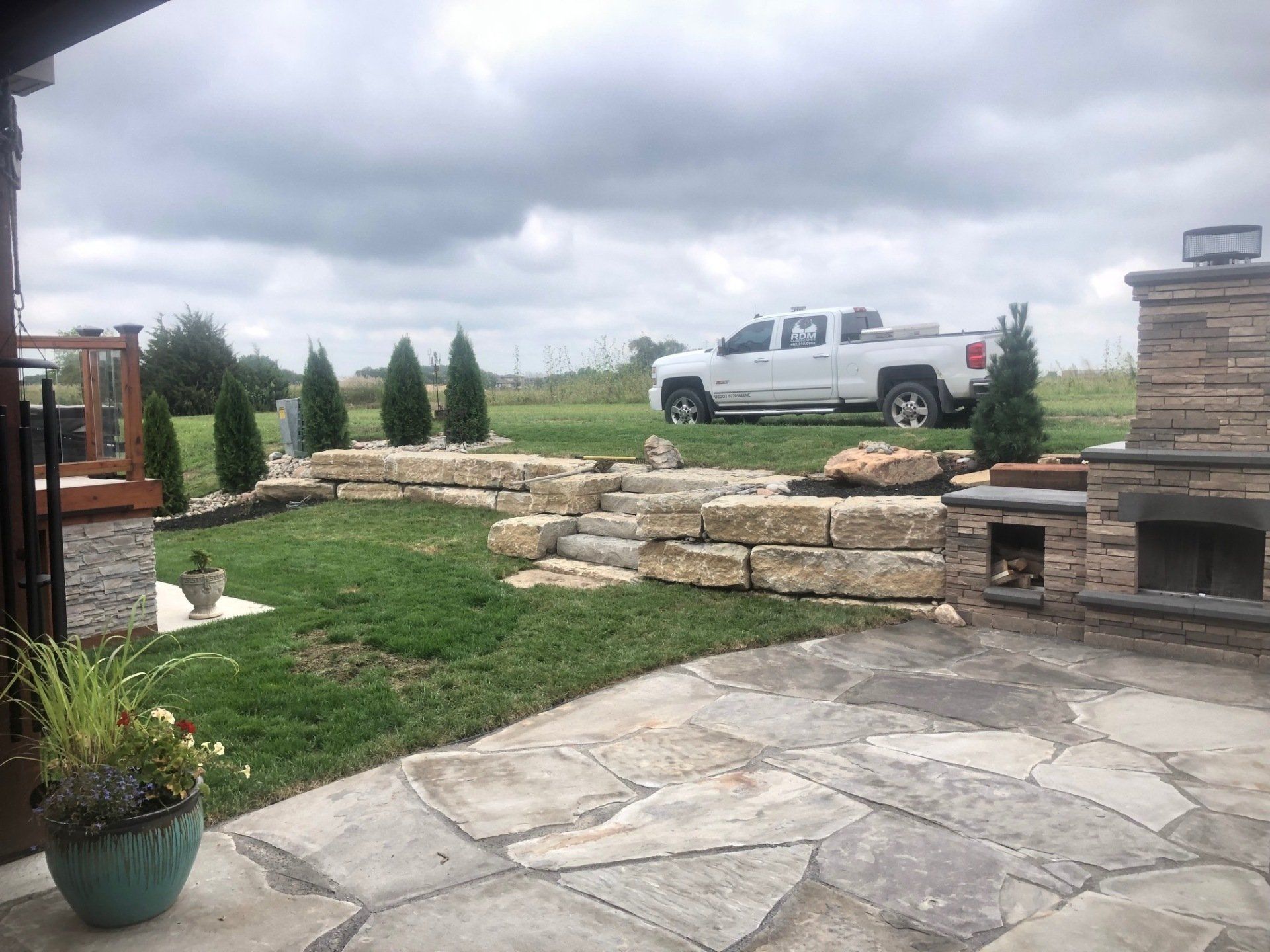 A white truck is parked in the backyard of a house.