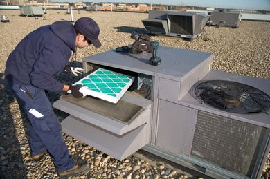 Inspecting roof top unit — Refrigeration Experts in New Port, OR Inspecting roof top unit — Refrigeration Experts in New Port, OR