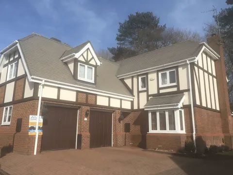 Large home with a grey tiled roof