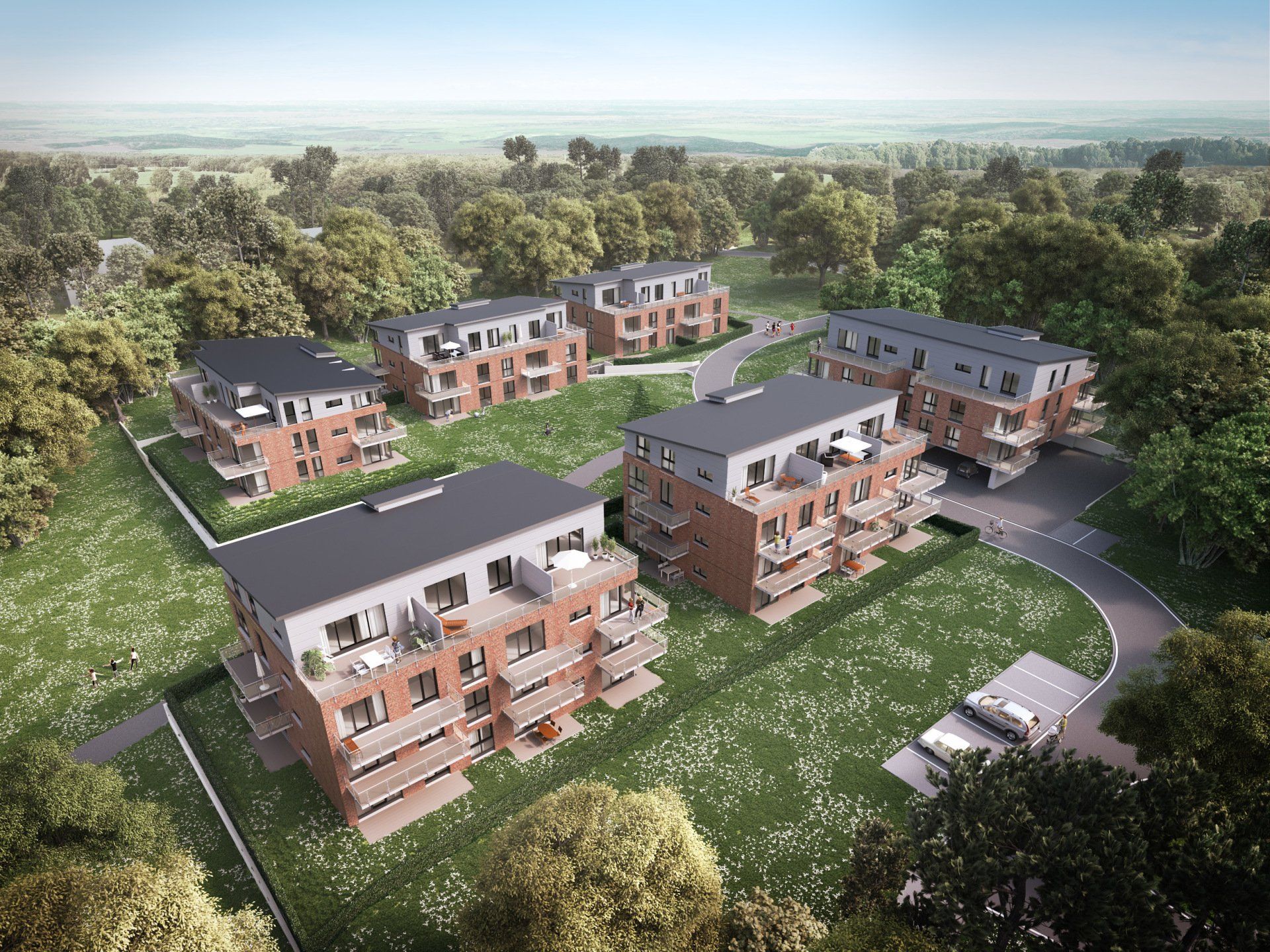 Luftaufnahme von modernen Backstein-Apartmentgebäuden, umgeben von Bäumen und Grünanlagen.
