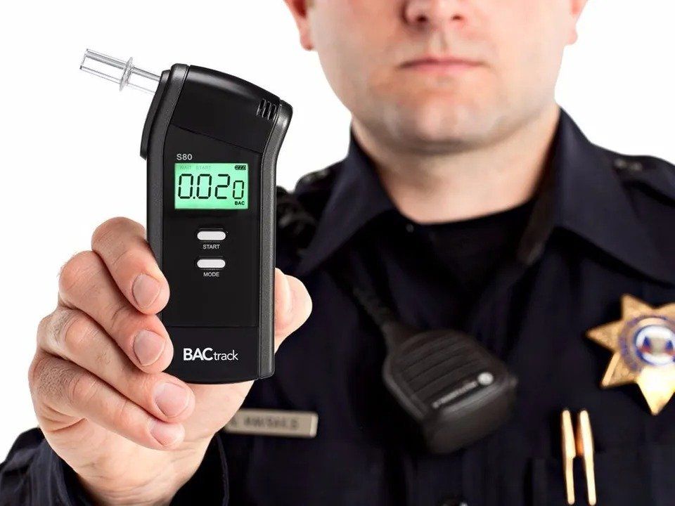 Cop Holding Breath Analyzer — Eau Claire, WI — Cohen Law Offices