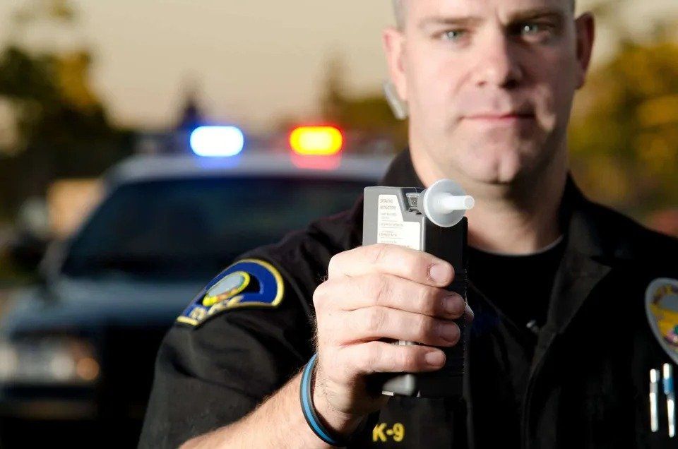 Police Holding Breath Analyzer — Eau Claire, WI — Cohen Law Offices Police Holding Breath Analyzer — Eau Claire, WI — Cohen Law Offices