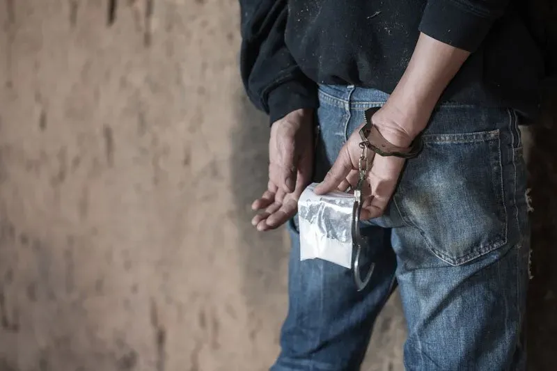 Man Holding Illegal Drugs — Eau Claire, WI — Cohen Law Offices Man Holding Illegal Drugs — Eau Claire, WI — Cohen Law Offices
