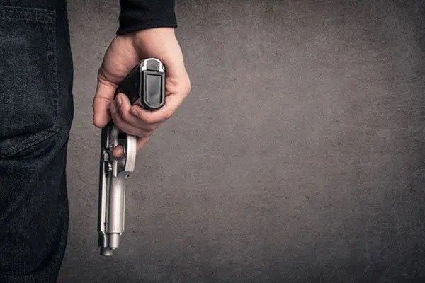 Man Holding Gun — Eau Claire, WI — Cohen Law Offices, LLC