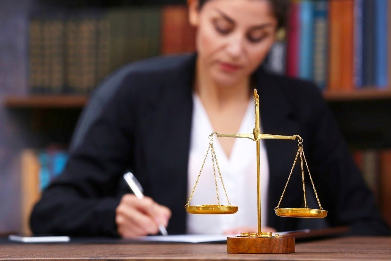 Lawyer Writing on a Paper — Eau Claire, WI — Cohen Law Offices Lawyer Writing on a Paper — Eau Claire, WI — Cohen Law Offices