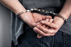 Handcuffed Man — Eau Claire, WI — Cohen Law Offices Handcuffed Man — Eau Claire, WI — Cohen Law Offices