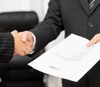 Lawyer with document in his handshaking with the client - Document Signing in Champaign - Urban, IL Lawyer with document in his handshaking with the client - Document Signing in Champaign - Urban, IL