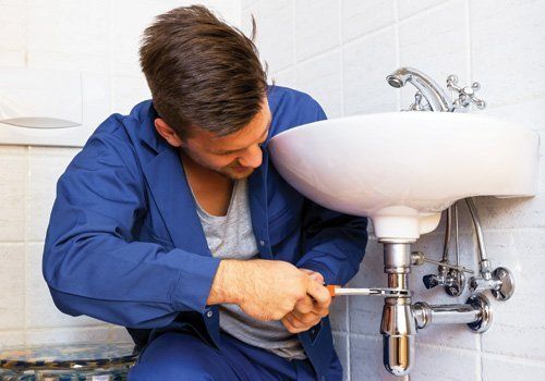 Plumber doing the bathroom repair work 