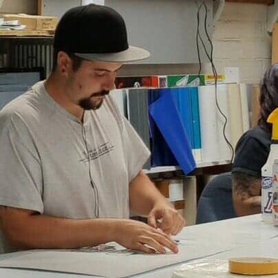 Man doing lettering — Custom signs in Tucson, AZ Man doing lettering — Custom signs in Tucson, AZ
