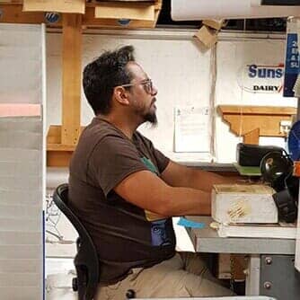 Man seating on chair — Sign repair in Tucson, AZ Man seating on chair — Sign repair in Tucson, AZ