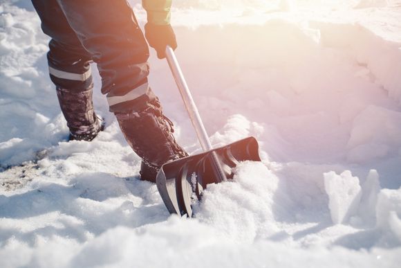 operaio con pala per neve