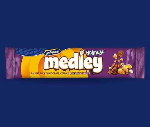 A bar of medley chocolate with nuts on a blue background.