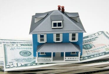 Toy house on stack of money- Legal services in Saint Petersburg, FL