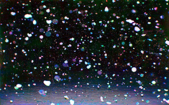 Snow falling in the night sky