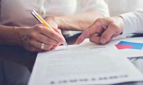 A man signing on a document