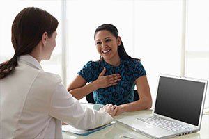Woman Talking to Doctor beside of Laptop — Gynecology in Monterey,CA