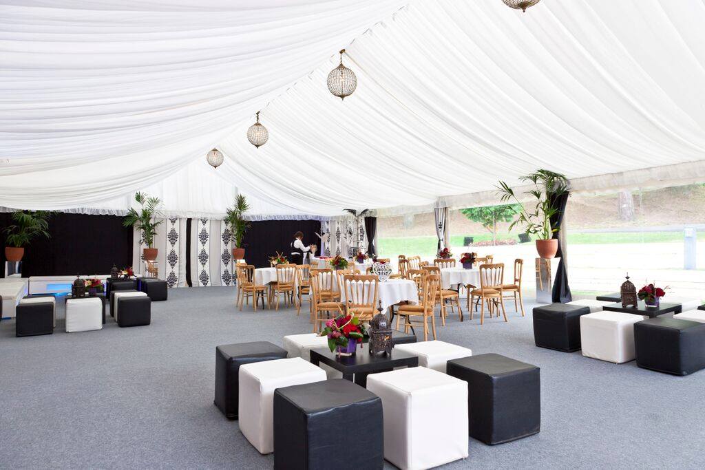 A large tent with tables and chairs inside of it