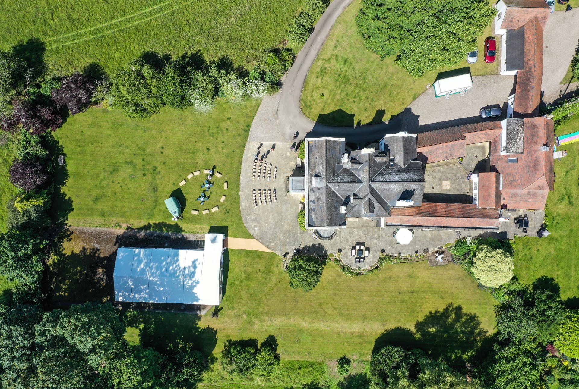 An aerial view of a large house and marquee hire in the garden
