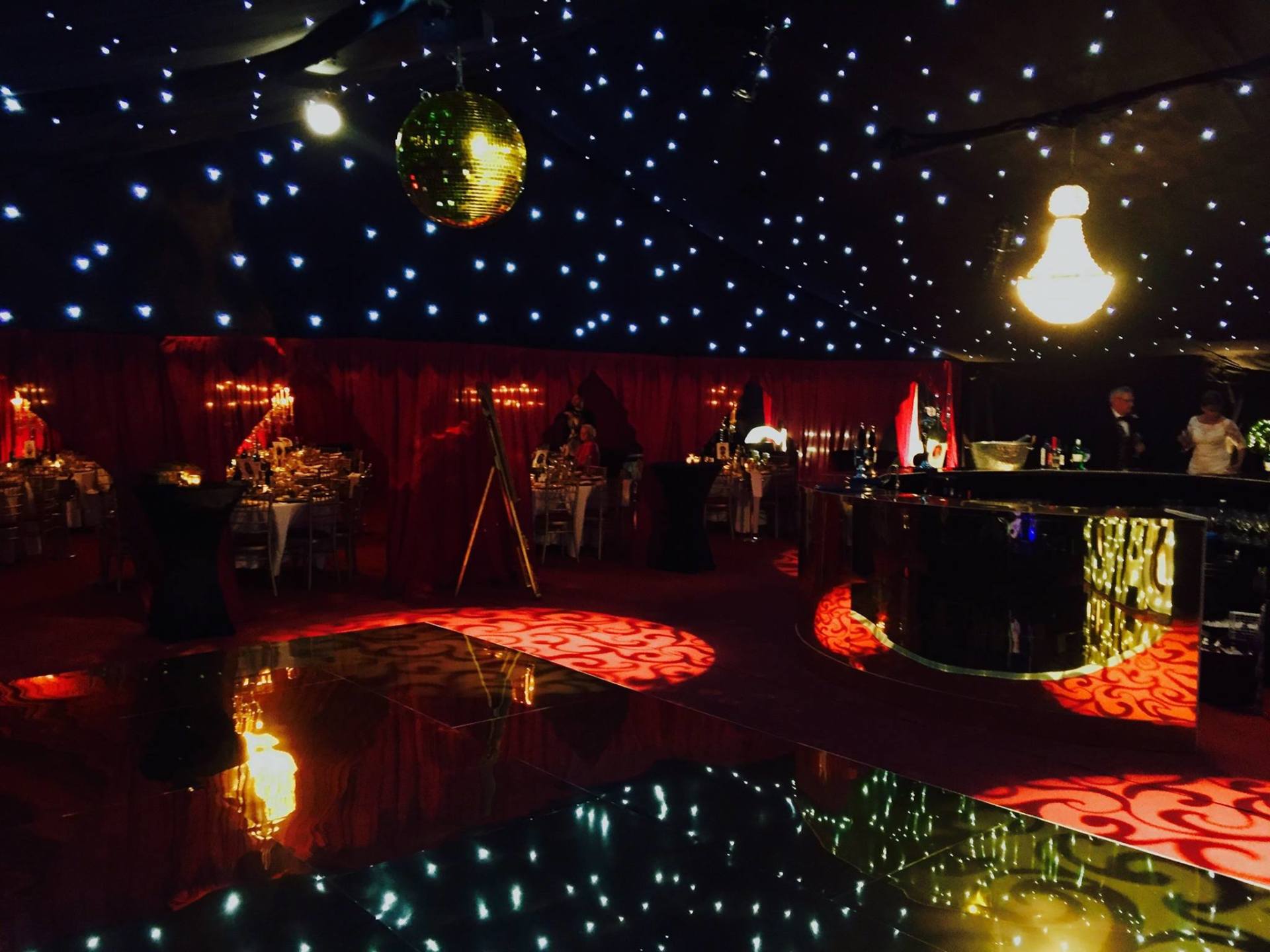 A large room with a disco ball hanging from the ceiling.