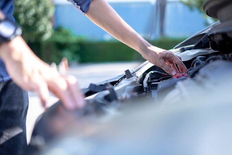 Man Checking on its Cars Battery — Dearborn, MI — Rusko’s Service Center