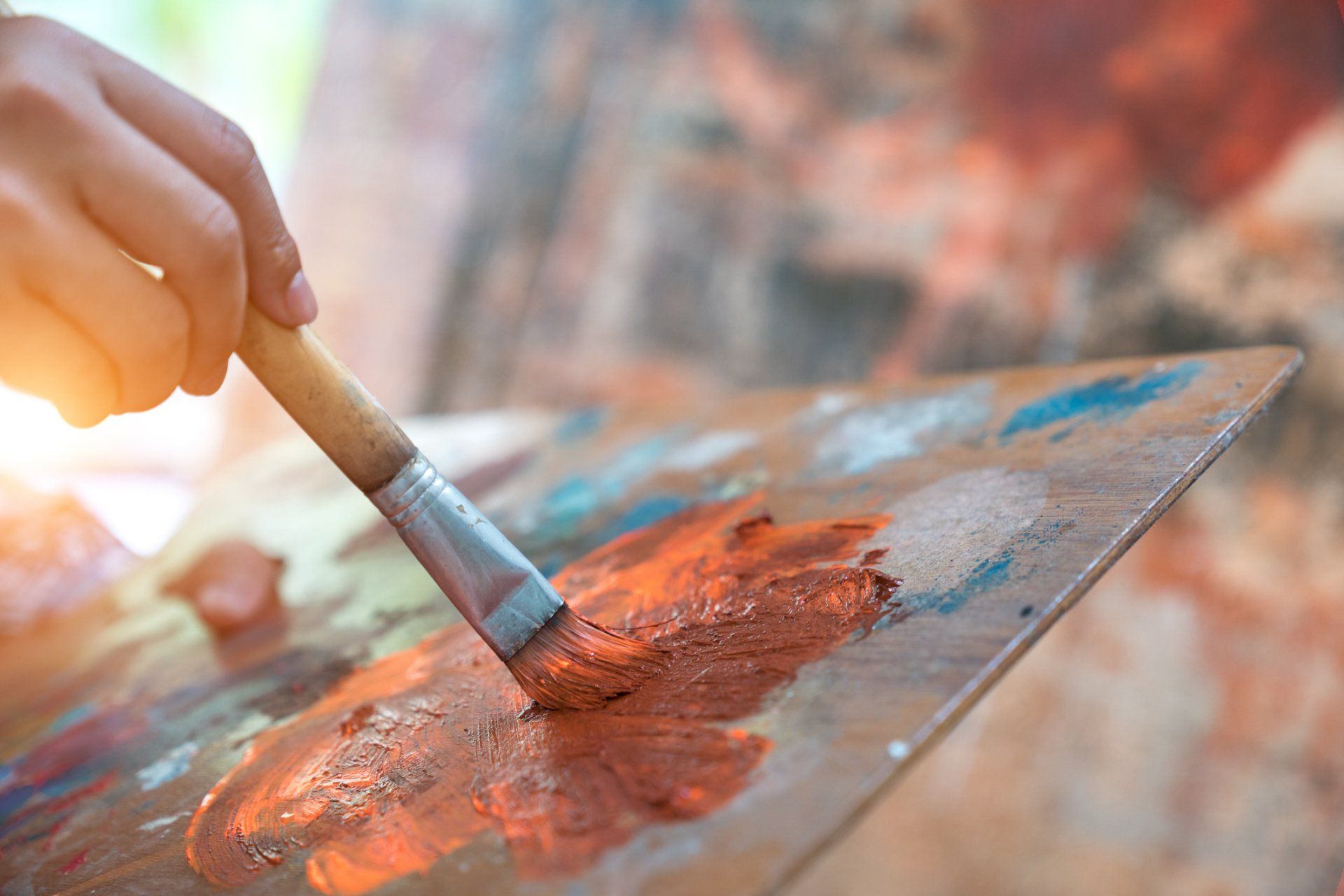 A close up of a paint brush and paint on a canvas