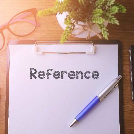 A clipboard with the word reference written on it