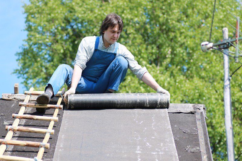a man in the form of a builder repairs a house