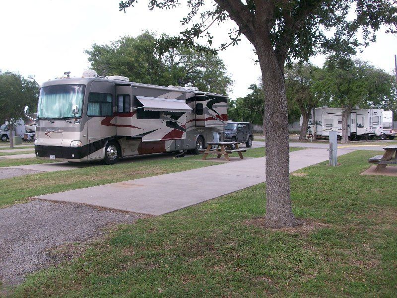 A large rv is parked in a grassy area