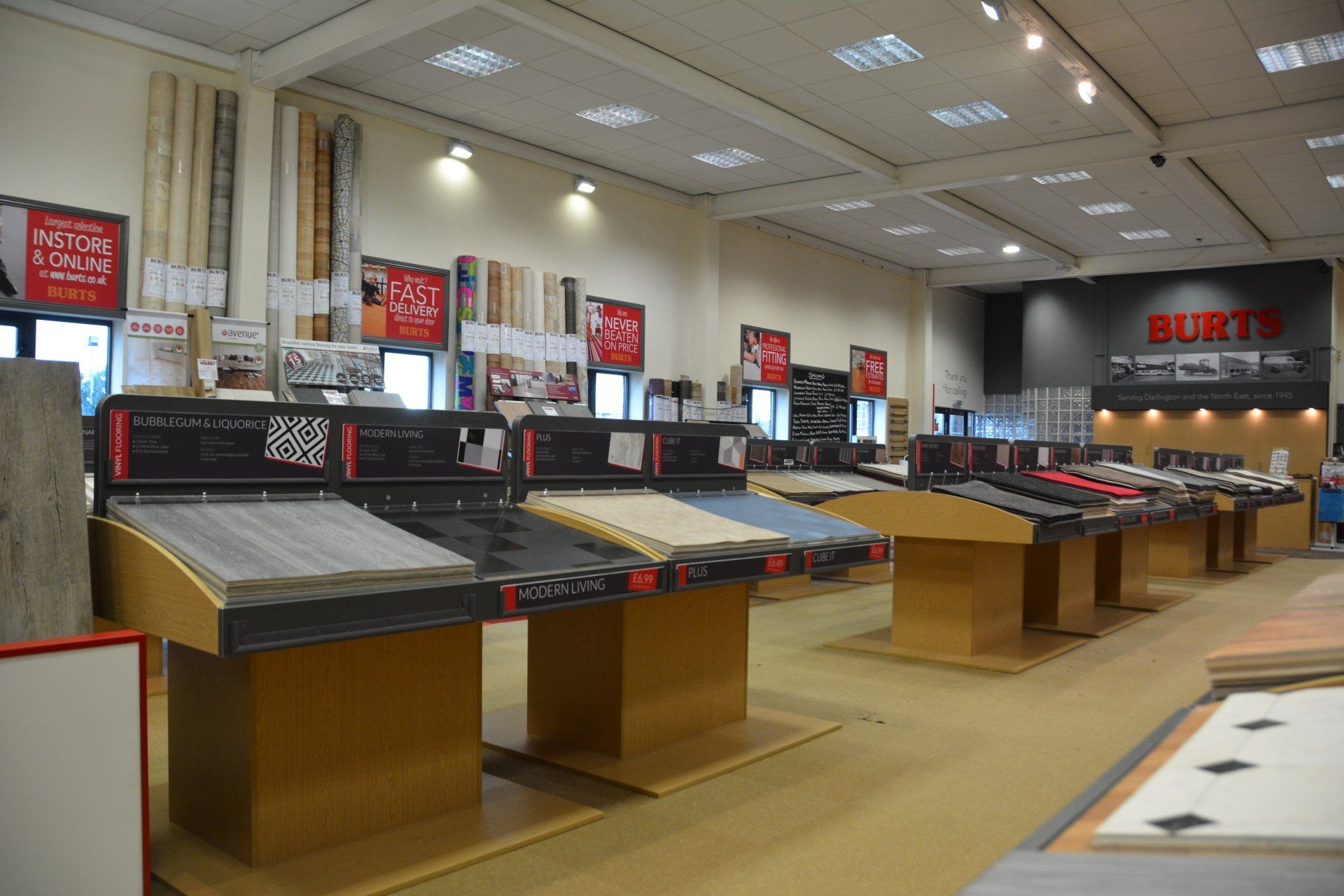 A large room filled with lots of tables and signs.