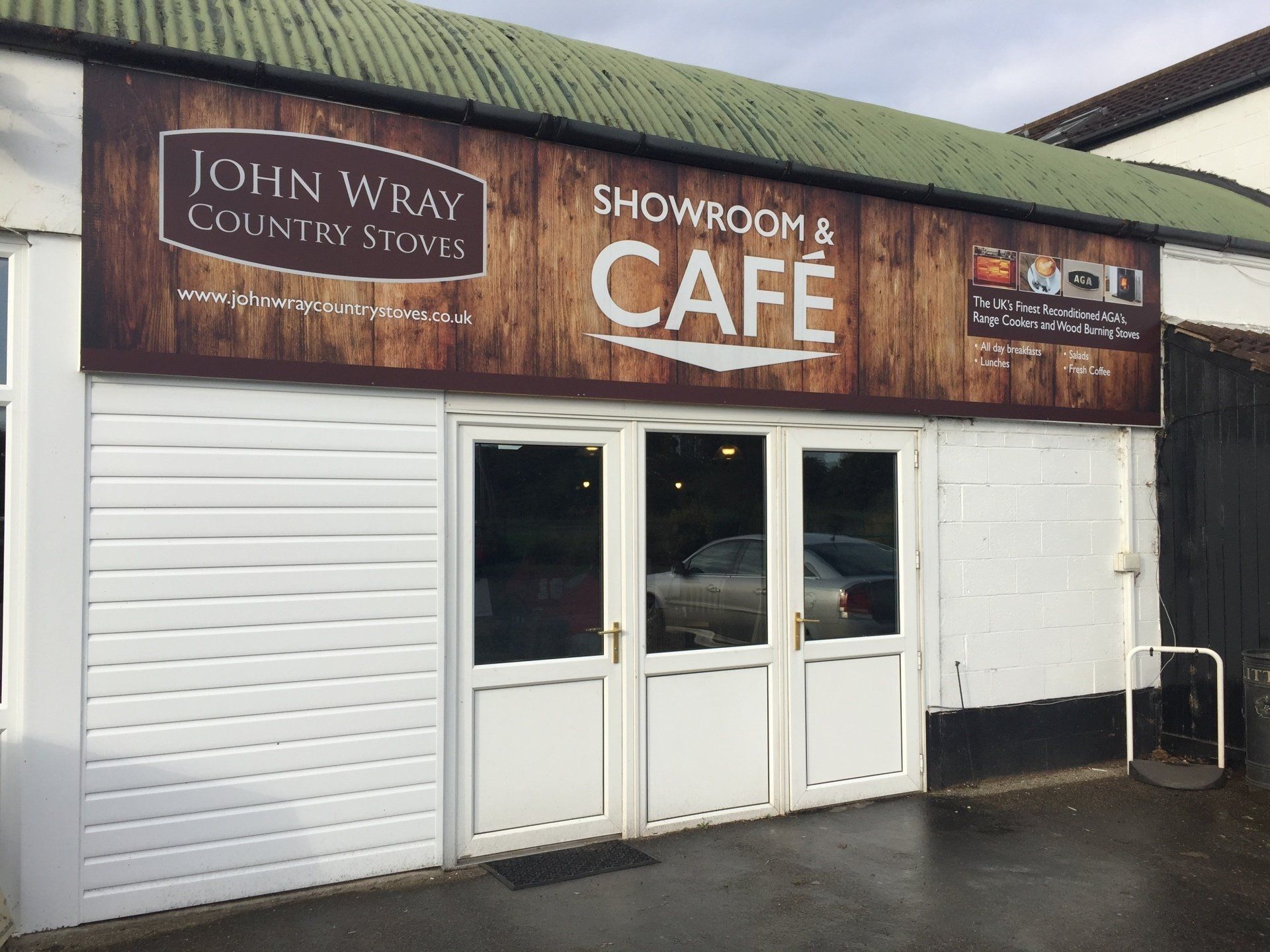 A building with a sign that says showroom & cafe