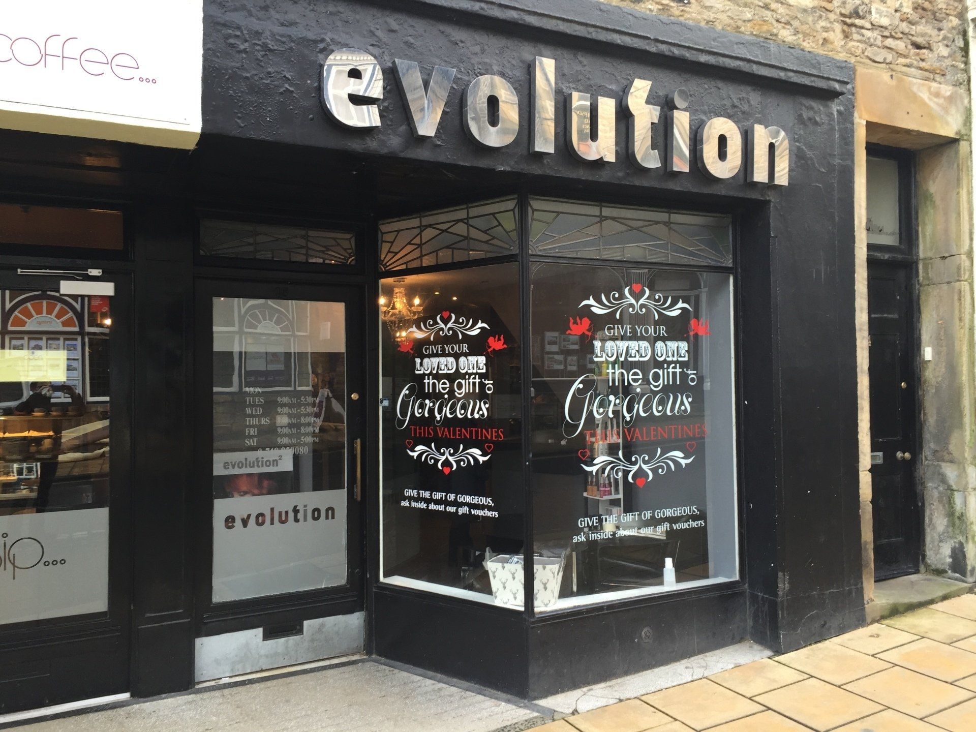 A store front with a sign that says evolution on it.