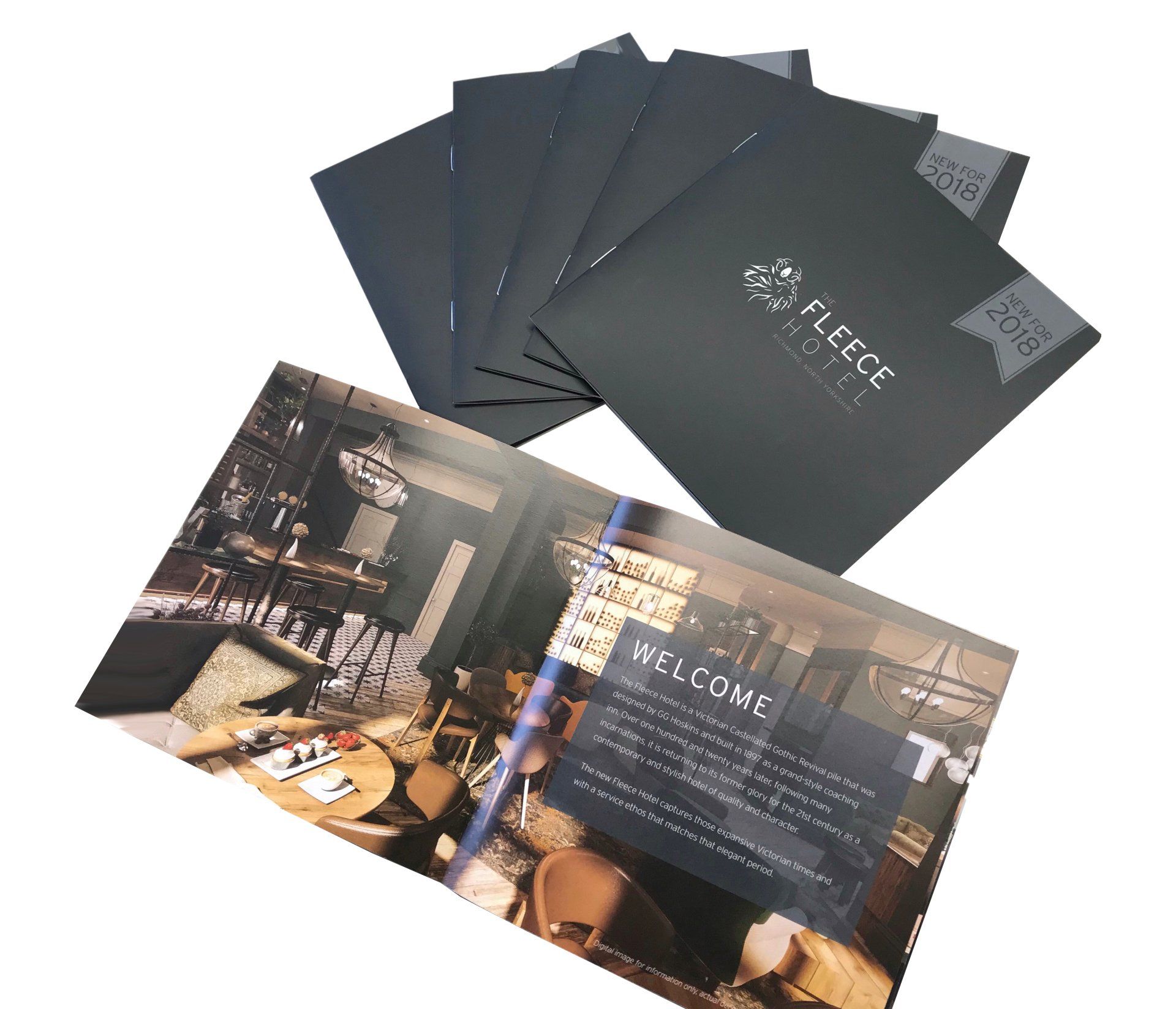 A stack of brochures sitting on top of each other on a table.