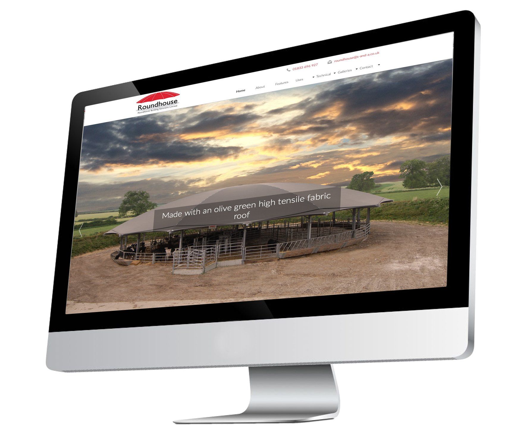 A computer monitor is displaying a picture of a farm.