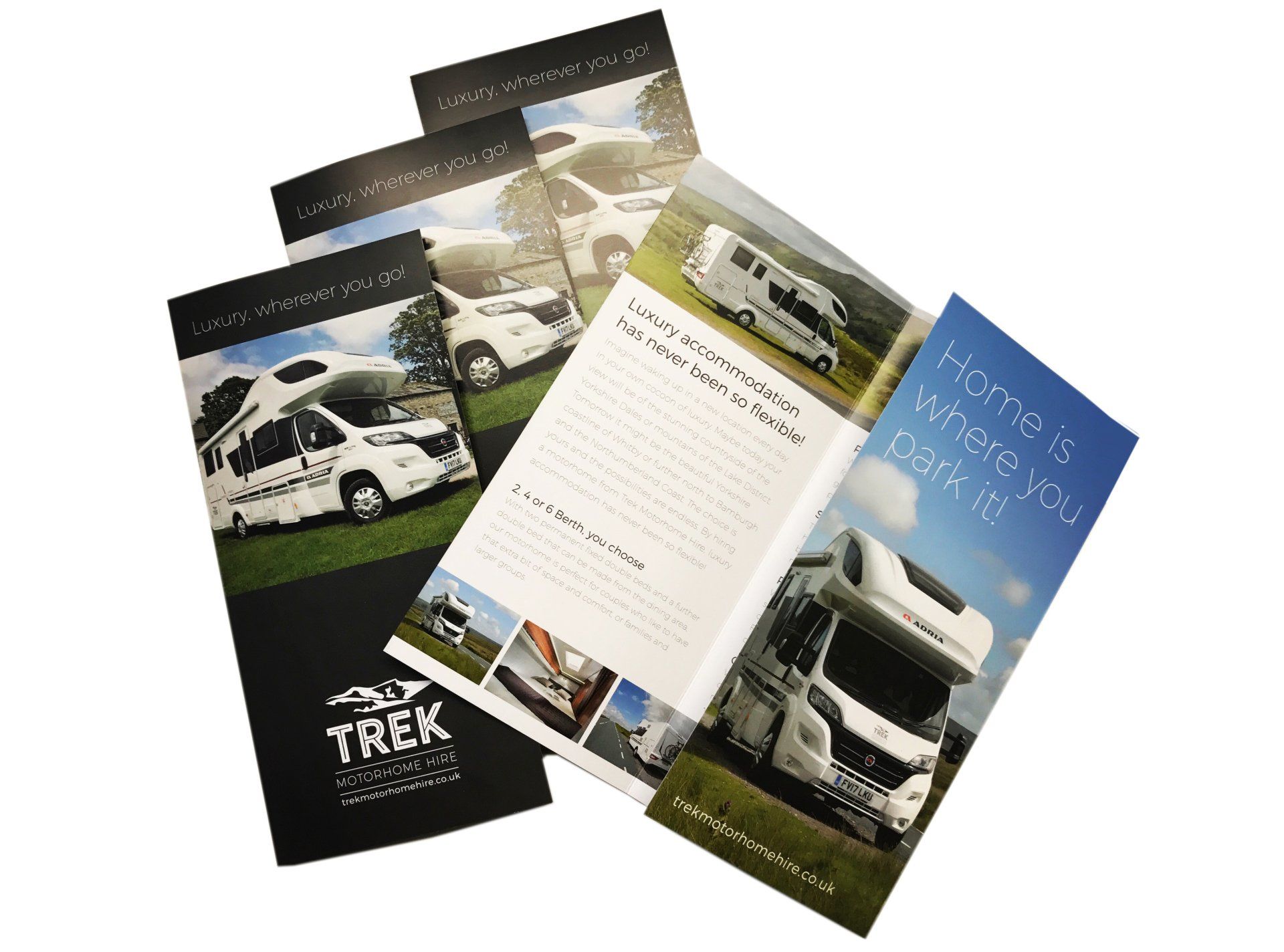 Three brochures for a company called trek are stacked on top of each other on a white background.