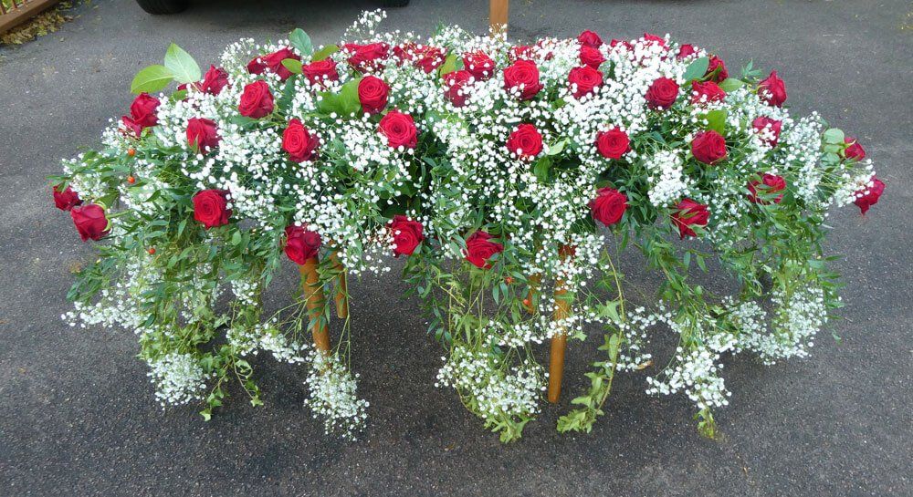 55.   7ft Coffin spray with extra large red Roses, Gypsophila and trailing Ivy