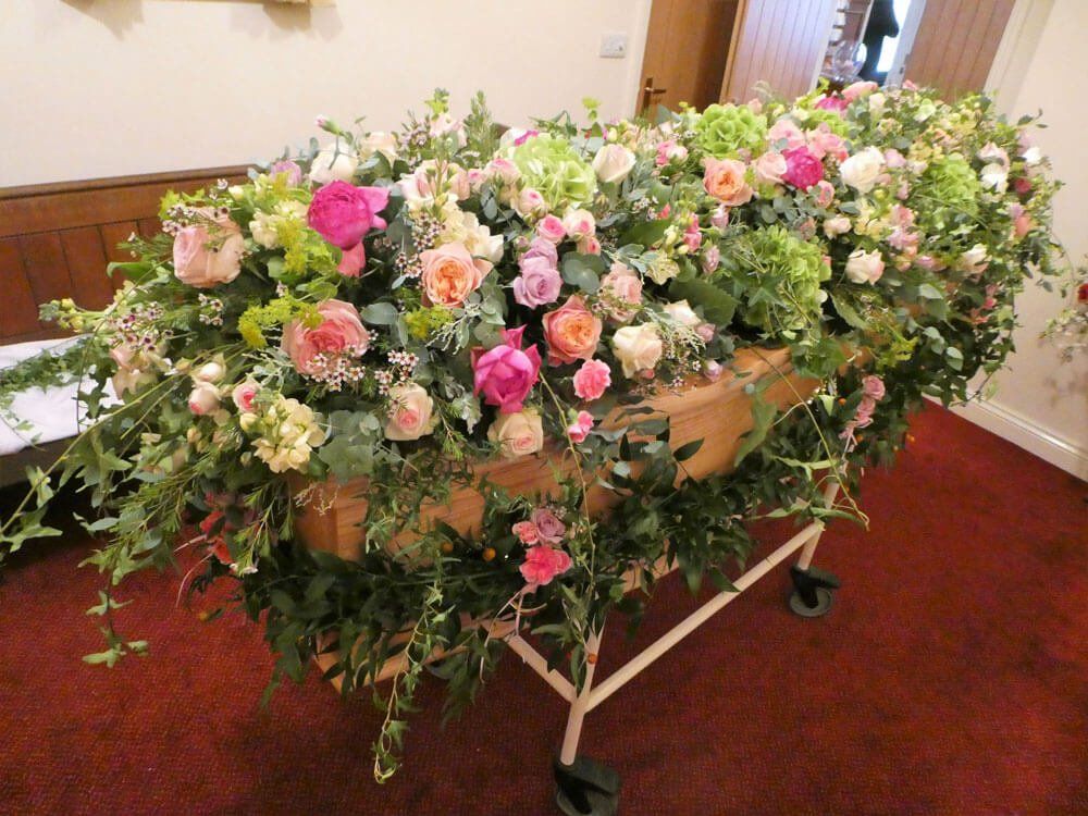 54.  7ft Coffin spray with masses of Roses and spray Roses, trailing Ivy and Coffin Garland