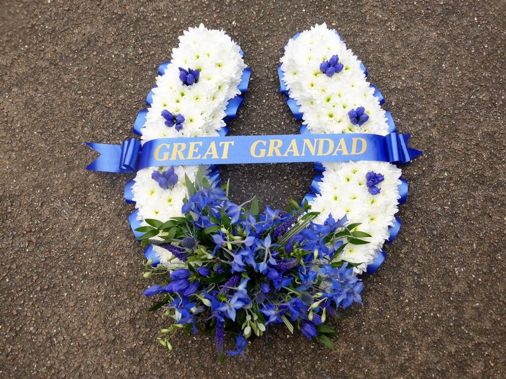 1.  Large Horseshoe in blue and white with blue ribbon edge and sash. Delphinium and Gentiana posy