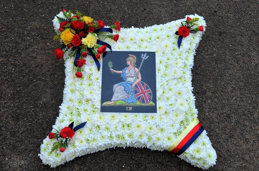 6.  23” white Cushion with the Royal Norfolk Regiment emblem to the centre and the colours in posies/ribbon to match