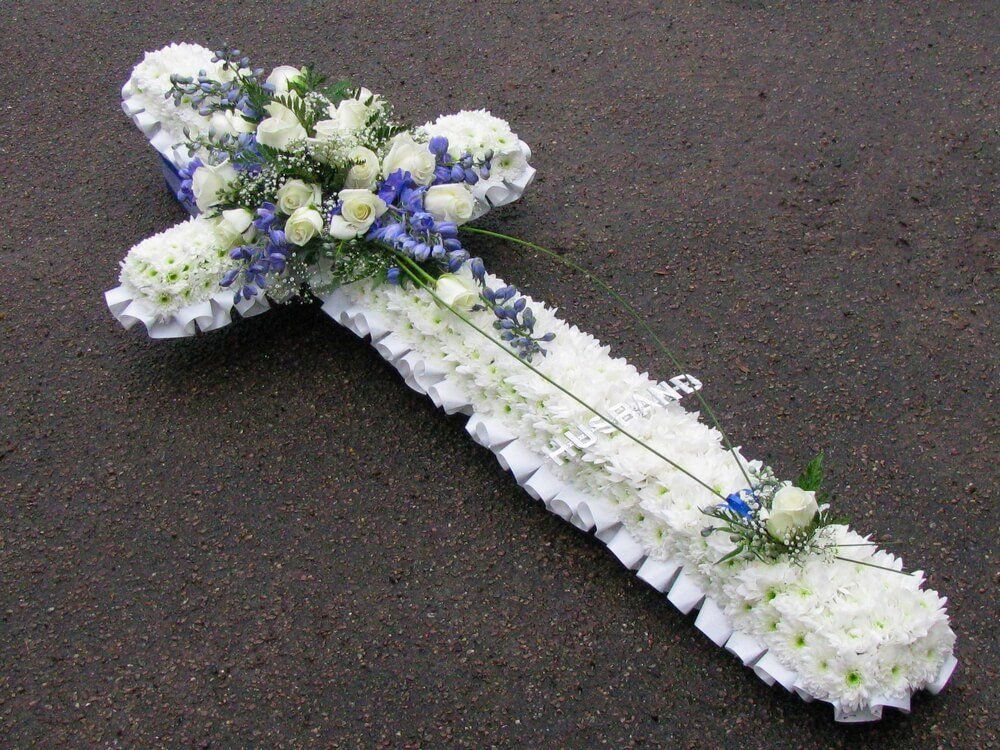 8.  5ft Cross with white ribbon edge, white Roses and blue Delphiniums with Aluminuim letters