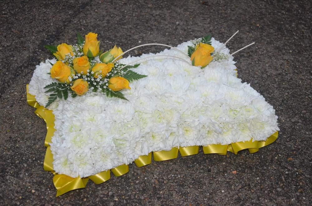 3. 15” White Pillow with yellow ribbon edge and posies of yellow Roses
