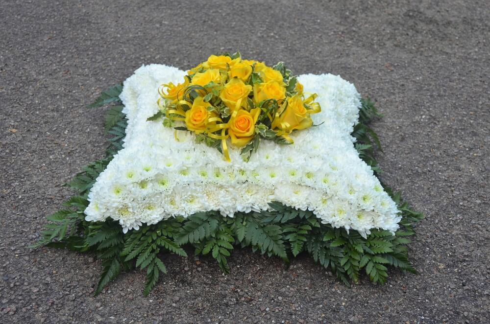 2.  15” Cushion in white with foliage edge and posy of yellow Roses to the centre