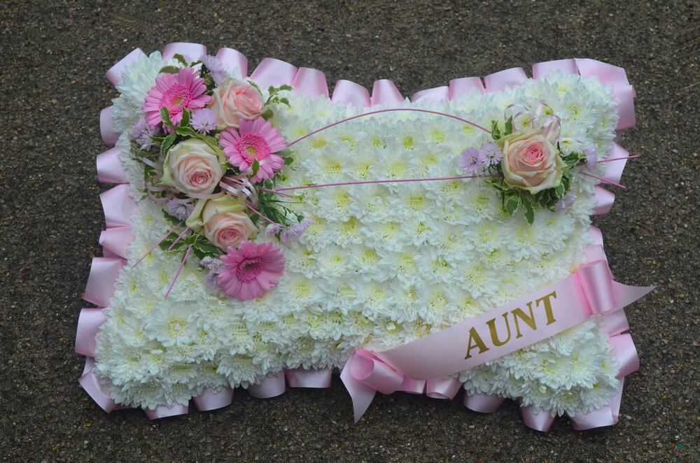 4.  18” White Pillow with pink ribbon edge and sash, posies of Germini and Roses