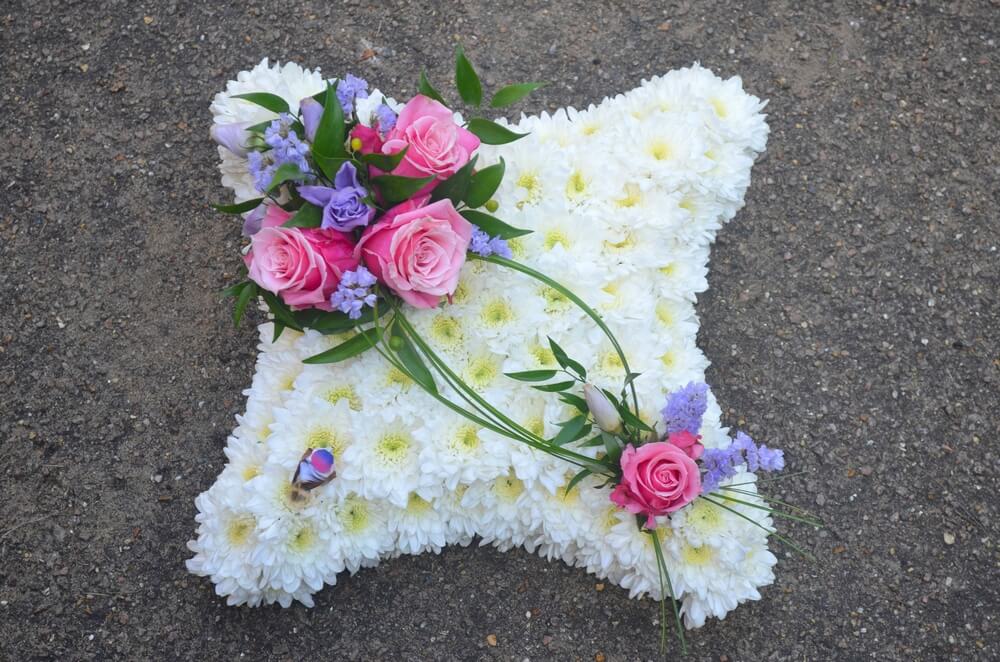 5.  12” White Cushion with pink and lilac posies and small feather bird