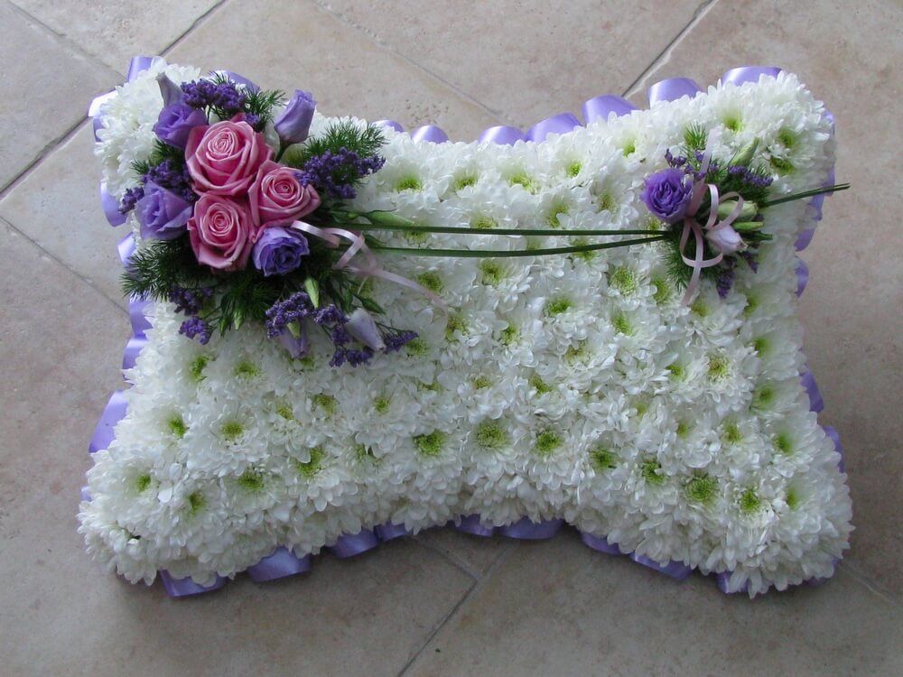 1.  18” White Pillow with lilac ribbon edge, posies of pink Roses and lilac flowers